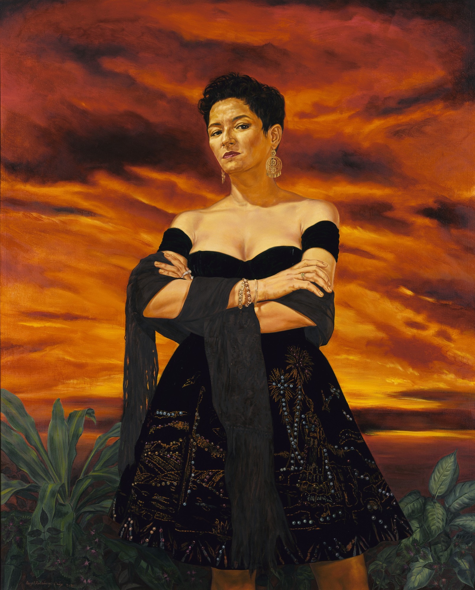 This life-size painting depicts a realistic portrait of a Chicana woman looking down at us, shown from the knees up, in a black strapless dress with a black shawl draped over her forearms. She is wearing dangling earrings, bracelets and rings, and the A-line skirt of her dress is embellished with a pattern of blue dots. Her arms are crossed and she is standing in a field with green plants beside her. The dramatic, orange-and-brown sky and clouds in the background fill most of the canvas behind and around her.
