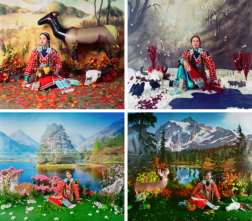 In this series of four photographs, the artist, a Native American woman wearing a red, long-sleeve dress sits on the ground facing us. She is sitting within obviously staged landscapes, surrounded by cardboard cutouts of animals or inflatable animals; fake plants; artificial turf or snow; and a printed, photo backdrop. Each photograph depicts a specific season – spring, summer, fall, or winter. Fall: In this staged fall scene, plastic, orange leaves cover the ground; plastic, orange-and-red flowers surround her; an inflatable deer stands on the right; and a printed backdrop of mountains hangs behind her. Winter: Sitting in styrofoam snow next to a plastic pond, the woman is surrounded by fake, black birds; white, Styrofoam snowballs; an animal skull; and faux, red berries. Behind her is a printed backdrop of trees and plastic snowflakes. Spring: The woman, sitting on artificial, green turf, is flanked by cardboard cutouts of a deer, rabbit, and coyote, and plastic, white flowers are scattered on the ground. Behind her, a printed backdrop depicts a sunny lake with pink, flowering shrubs, and mountains in the distance. Summer: The woman looks slightly toward her left and sits in the center on artificial, green turf in front of a printed backdrop that depicts a sunny mountain scene with a lake. A cardboard cutout of a deer stands to her right, and a plastic skull with horns is laid on the turf near her left. Plastic, yellow-and-orange flowers dot the turf.