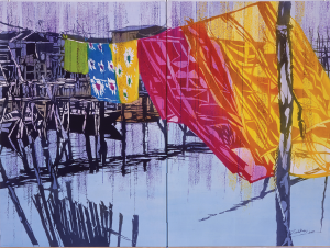 Brightly colored fabrics in pink, yellow, blue, and green, hang from a long clothesline, moving with the breeze. The surrounding scene, depicted in grey-blue monotone, suggests that the fabric is suspended above a calm body of water with rough structures in the background.